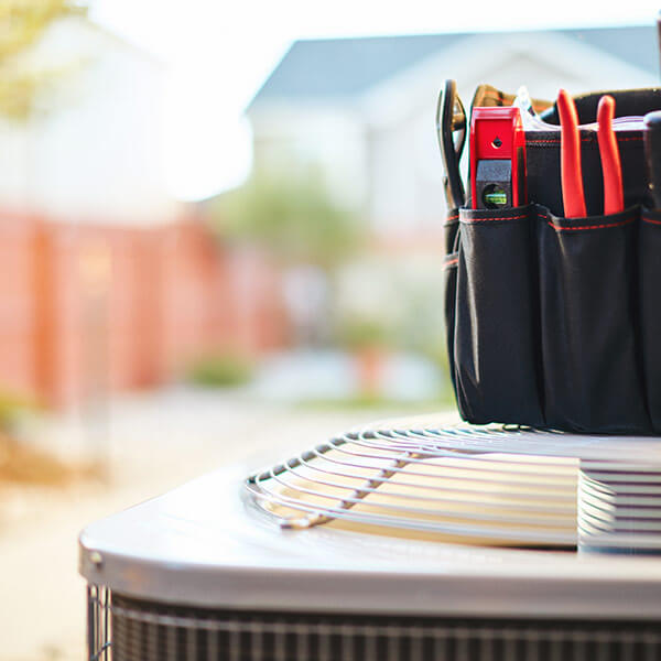 tools resting on outdoor ac